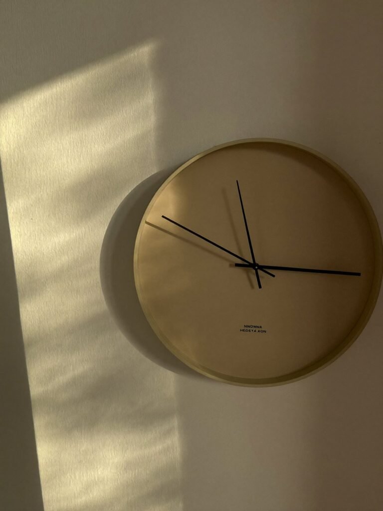 Analogue wall clock in afternoon light representing the two hour herbal colour routine
