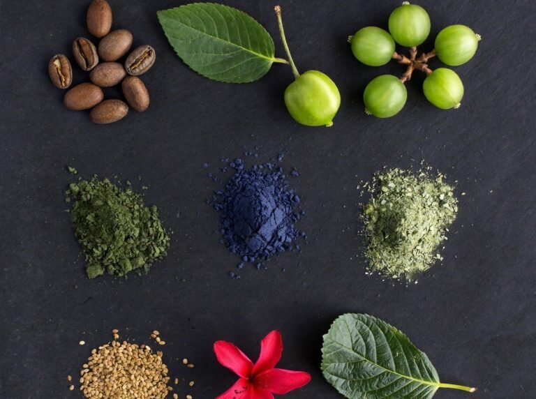 All nine Keshkalini herbs laid out separately including henna indigo amla and hibiscus
